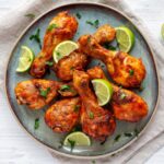 homemade grilled jerk chicken with lime on a plate 2024 07 19 21 42 09 utc