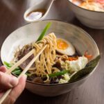 man eating asian ramen with tuna and noodles in a 2023 11 27 05 22 14 utc (1)